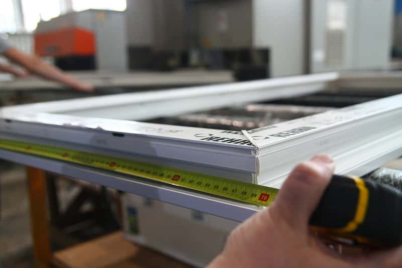 pomiar miarką przekątnej gotowej ramy okiennej w celu kontroli dokładności wymiar&oacute;w geometrycznych